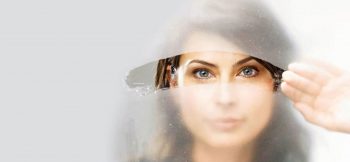 девушка смотрит сквозь запотевшее стекло