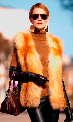 оранжевый жилет из искусственного меха на девушке